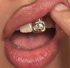 a close up of a person's mouth with a ring on it