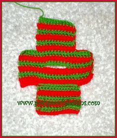 two crocheted red and green mittens on white carpet