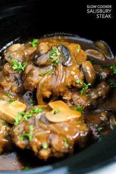 a bowl filled with meat and mushrooms covered in gravy