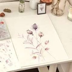 a white table with flowers and pictures on it