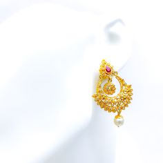 These exquisite 22k gold hanging earrings, weighing a total of 19.0 grams with a gold net weight of 16.2 grams, feature a refined and glamorous design adorned with uncut diamonds (Polki), rubies, and pearls. The yellow gold finish enhances their luxurious appeal, making them perfect for any special occasion. The uncut diamonds, totaling 1.8 carats, come in irregular round shapes, adding a unique sparkle. Complementing the diamonds are rubies and pearls, weighing 5.7 carats and shaped in spheres and pear drops, adding a touch of color and elegance. With a length of 2 inches and a hanging style, these earrings offer a sophisticated and comfortable fit, secured with screw-back posts. Ideal for those who appreciate high-quality craftsmanship and timeless beauty, these glamorous earrings are a 22k Gold Pearl Earrings For Festivals, Gold Chandbali Pearl Earrings, Gold Pearl Drop Earrings For Reception, Elegant 22k Gold Pearl Earrings For Festivals, White 22k Gold Chandbali Earrings, 22k Gold Pearl Drop Earrings, Elegant Gold Chandbalis For Reception, Traditional Gold-plated Yellow Gold Pearl Earrings, Gold Kundan Pearl Earrings For Reception