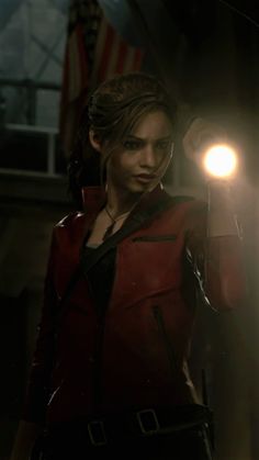 a woman in a red jacket holding a light