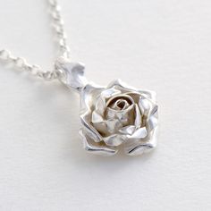 Rose Pendant Necklace, Flower Jewelry, Rose Necklace This exquisite Silver Rose Necklace makes a truly romantic gift! The pendant features a beautiful rose suspended by delicate thorns. * Material: Sterling Silver * Size of Rose: Approx 1 cm (0.4in) diameter * Length of Chain: 40 cm (16in) * Ready to Ship in 2-3 business day * Made in the United Kingdom PACKAGING: Comes uniquely packaged in my Magnolia Restrepo Style Case as shown in the last photo. Additional, I gift wrap all my boxes with gold Rose Shaped Urn Necklace Sterling Silver, Unique Romantic Gifts, Collar Rosa, Rose Pendant Necklace, Anniversary Necklace, Christmas Necklace, Necklace Flower, Prom Jewelry, Rose Gift