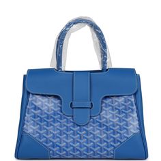 This Goyard Saigon soft tote is in blue Goyardine coated canvas and chevroches calfskin with palladium hardware, contrast stitching, features two double rolled top handles, signature Saigon leather strap and loop closure, and a cutout in the top of the flap for the handle to fit through.The Interior is lined is white canvas and blue chevroches calfskin, single floating pocket and a wooden detail on back of bag with palladium studs.Origin: FranceCondition: New and never worn (plastic on handles)Accompanied by: Goyard box, dustbag, felt, carebook, ribbonMeasurements: 13" x 9.5"x 6" Goyard Saigon, Hermes Birkin 35, Hermes Birkin 25, Birkin 25, Madison Avenue, Rose Gold Hardware, White Canvas, Hermes Birkin, Sky Blue