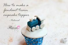 a blue and white cupcake with a train on top