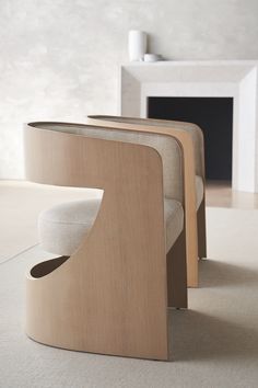 a modern wooden bench sitting on top of a white carpeted floor next to a fireplace