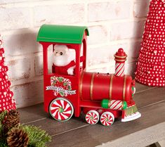 a red and green christmas train with santa clause on it