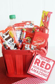 a red basket filled with lots of candy