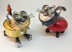 two metal cats sitting on top of each other