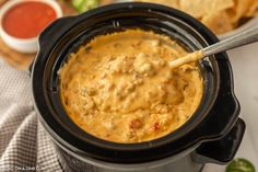 a slow cooker filled with some taco dip