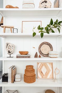 the shelves in this room are filled with decorative items