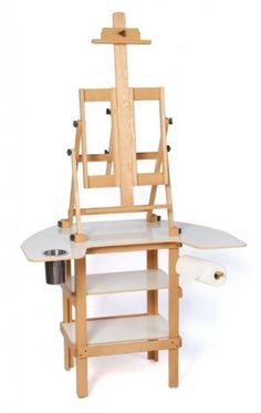 a wooden easel with a painting stand and paint rollers on the bottom shelf