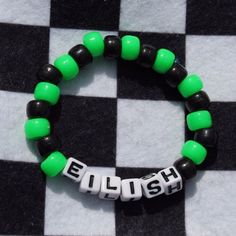 a green and black beaded bracelet with the word eliush on it