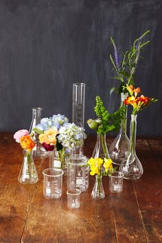 a person arranging flowers in vases on a table