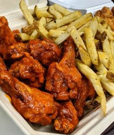 chicken wings and french fries in a takeout container