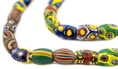 WOW! Take a look at this beautiful antique strand of Venetian Millefiori trade beads! Celebrated among the most distinctive of beads, the Millefiori has become nearly synonymous with the West African Trade. Made from famed Murano glass, Millefiori beads derive their name from the Italian words for “Thousand Flowers” due to the characteristic floral motifs that decorate their surface. Millefiori beads were made throughout the 19th and 20th century primarily for export to Africa. Today they are fo Millefiori Beads, Italian Words, African Trade Beads, Fancy Beads, African Jewelry, Trade Beads, Floral Motifs, Murano Glass, Floral Motif