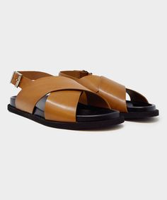 The MANJAK Sandal is an expression of comfort and ease, perfect for warm-weather dressing. These versatile slides will take you from day to night easily and elegantly with their crossover design and simple, buckle closure. Made from premium Italian calf leather, the MANJAK Sandal is crafted by traditional shoemaking artisans, offering a soft and supple finish. DETAILS- Exclusive- Men’s - Premium Italian Calf Leather- Molded footbed- Lightweight Rubber Sole- Built for 12-hour wear- Buckle closure Sweatshorts Shorts, Square Shoes, Polo Coat, Linen Tshirts, Sneaker Dress Shoes, Day To Night, To Night, Tie Shoes, Shoe Care