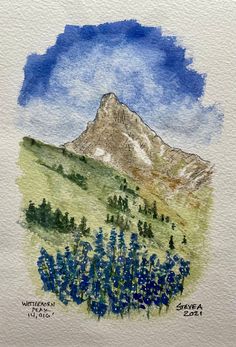 a watercolor painting of a mountain with blue flowers and trees in the foreground