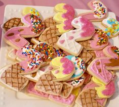 a white plate topped with lots of decorated cookies