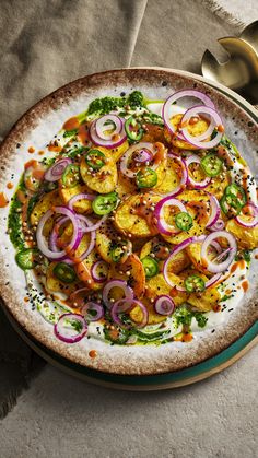 A plate of fried potato slices sitting on top of a plate of cool yoghurt. Topped with chaat masala, chillies, red onion slices and coriander yoghurt. Vegan Chutney Recipes, Gourmet Indian Food, Modern Indian Food, Indian Feast, Indian Sides, Colourful Food, Asian Sides, Indian Dinner Party, Indian Starters