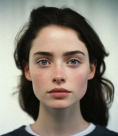 a woman with blue eyes is looking at the camera