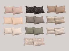 a bunch of pillows sitting on top of each other in different sizes and colors,