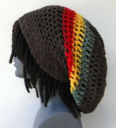 a crocheted hat with dreadlocks on top of a mannequin head