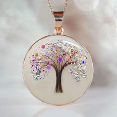 Beautiful handmade item! Here, on Etsy made as simulation only-just resin and white color.  If you need to send the hair to us, please send the hair right after the purchase to: KEEPSAKEMOM CREATIONS 1733 H ST, STE 450 PMB 2775 BLAINE WA 98230 "Tree of Life" disc pendant with baby hair and birth color flakes and shimmers, baby name, date. Yellow or Rose Gold plating over 925 sterling silver cup and chain. This pendant is made with white resin only, no milk. Our "Tree of Life" Pendant necklace is a simple, tasteful 20mm circle  has a 20 inch flat cable chain. We can put a lock of hair from one child or from two or three of your children or your loved one. Please specify in the drop-down menu if you want birth month color shimmer and/or name.  For jewelry made with your  breast milk, please Personalized White Round Necklace, Personalized Round White Necklace, White Pendant Necklace For Personalized Gifts, White Round Necklace For Memorial, White Memorial Necklace, Hypoallergenic White Necklace As Gift For Mom, White Round Necklaces For Memorial, White Resin Pendant Jewelry, White Tree Of Life Jewelry Gift