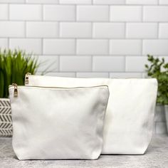 "Our bright white blank polyester canvas cosmetic bags are available in two sizes, 11x7x2\" and 8x6x3.5\" and have a nice lining. The Details: -Single Zip Pouch -Choose from two sizes -100% white polyester canvas - zip top -white lined interior -all items are handmade, a slight size difference of 1/2\" is possible. To order, simply select the style you prefer from the dropdown menu, add to cart, and checkout. To shop more of our sublimation blanks, or other boutique items, head over to https://w White Zipper Pouch For Everyday Use, White Rectangular Canvas Bag For Personal Use, Everyday White Zipper Pouch, Rectangular White Canvas Bag For Personal Use, White Rectangular Pouch For Daily Use, Rectangular White Pouch For Daily Use, White Zipper Pouch For Personal Use, White Pouch Cosmetic Bag For Daily Use, White Rectangular Cosmetic Bag For Daily Use