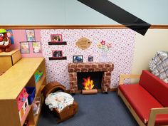 a child's playroom with toys and furniture, including a fire place in the fireplace