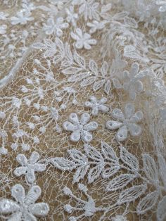 closeup of white lace with flowers on it