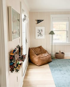 a living room with a brown bean bag chair and blue area rug on the floor