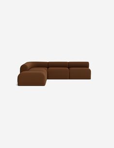 a brown sectional couch sitting on top of a white floor