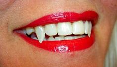 a woman's mouth with white teeth and red lipstick