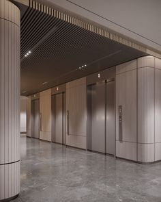 an empty room with three elevators and several doors