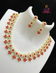 This traditional Gold Plated Exclusive Floral Motif Necklace boasts an exquisite design, with its pearls and red coral stones woven in an elegant flower pattern. Crafted with the finest Gold Plating and an intricate design, this piece is perfect for adding a touch of sophistication to any traditional saree. Carefully designed to make sure you stand out from the crowd. Coral Jewelry Design, Pearl Coral Necklace, Coral Gold Necklace, Coral And Pearl Necklace, Coral Necklace Indian Gold, Coral Necklace Designs, Coral Jewelry Indian Gold, Corals Jewellery, Pearls Jewelry Indian