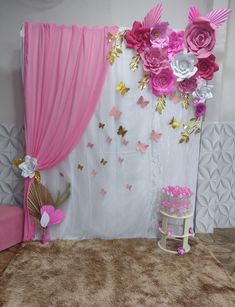 a room with pink and gold decorations on the walls, curtains, and rugs