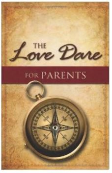 the love dare for parents book cover with compass on parchment paper and red ribbon around it