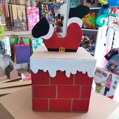 a cardboard box that is shaped like a santa's chimney on top of a table