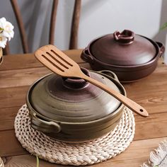 a wooden spatula sitting on top of a pot