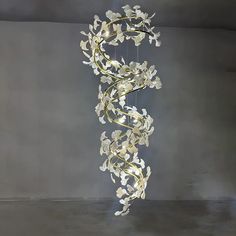 a chandelier with white flowers hanging from it's sides in a room