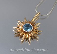 SOLAR ECLIPSE bronze and silver sun pendant with London Blue Topaz Ready to ship Mystical Sun And Moon Design Round Pendant Jewelry, Blue Celestial Pendant Jewelry, Mystical Sun And Moon Pendant Necklace, Silver Sun Pendant, Celestial Sun Design Pendant Necklace, Sun And Moon Rings, Viking Knit, Moon Ring, Cameo Necklace