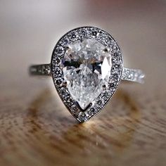 an engagement ring with a pear shaped diamond