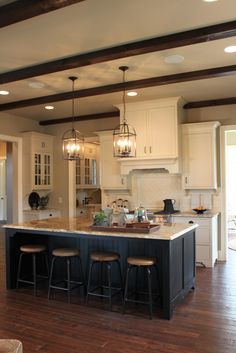 a large kitchen with an island in the middle