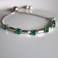 This sterling silver 3 mm Emerald Gemstone Bolo Bracelet is simply elegant. She'll love the versatility this bracelet offers as it pairs amazingly with fine fashion and casual wear. The bracelet is comfortable and easy to adjust to your liking with the pull tie and ball clasp. A thoughtful gift for a May Birthday and a variety of other occasions and events. Explore All Of Our Timeless Jewelry: https://www.etsy.com/shop/JOHNWESHDESIGNS All JohnWeshDesigns jewelry is handcrafted and designed to me Silver Birthstone Bracelet For Formal Occasions, Formal Silver Bracelet With Birthstone, Elegant Cubic Zirconia Bracelet With Birthstone, Adjustable Fine Jewelry Bracelets With Stones, Elegant Sterling Silver Bracelets For May Birthstone, Silver Birthstone Bracelets For Formal Occasions, Fine Jewelry Bracelets With Stones, Silver Bracelet For Anniversary With May Birthstone, Silver Sterling Bracelets For May Birthstone