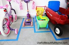 two children's tricycles, one red and one blue, are parked next to each other