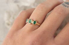 Three emeralds are embedded into this magical piece of treasure! Bezel set in 14k gold, this ring is inspired by ancient jewelry. Made of recycled 14k yellow gold Currently size 5.5 Due to the nature of the settings, this ring can only be resized up or down 1 size, if you need a size that is outside of the 1 size range, email me! Depending on my stock, I can make you a custom ring in any size! The inclusions and imperfections on these stones are natural. I choose to use perfectly imperfect stone Timeless Emerald Birthstone Ring, Heirloom Three-stone Emerald Ring, Green Emerald Three Stone Ring In 14k Gold, Timeless Green Emerald Ring Stamped 14k, Timeless Green Emerald Ring In 14k Gold, Timeless Three Stone Emerald Ring Gift, Three Stone Emerald Ring In 14k Gold, Timeless Three-stone Emerald Ring As A Gift, Timeless Three Stone Emerald Ring As A Gift