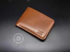 "Personalized Bespoke Full Grain Leather Wallet, Custom Engraved Wallet, Christmas Gift for Him, Gift for Husband, Classic Bifold Mens Wallet Discover the perfect Anniversary and Christmas gift for him with Bellicose Leather Company's Classic Bifold Leather Wallet, a timeless symbol of quality and style. Personalized and expertly handcrafted, this wallet is not just an accessory, but a meaningful piece of artistry. Uncompromising Quality: Our commitment to excellence begins with the materials we select. We use premium full grain leather, with options like Dark Brown and Brown showcasing a unique two-tone color method. While all brown variants feature the coveted \"pull-up\" feature for added character and resilience, the Black version, crafted from fine cell finish cowhide leather, exudes Classic Bifold Wallet With Engraved Logo, Classic Wallets With Engraved Logo For Everyday Use, Classic Wallets With Engraved Logo, Leather Wallet With Engraved Logo For Everyday Use, Leather Wallets With Engraved Logo For Everyday Use, Leather Trifold Wallet With Engraved Logo, Leather Trifold Wallet With Engraved Logo For Everyday Use, Bifold Wallet With Engraved Logo As Gift, Leather Bifold Wallet With Engraved Logo