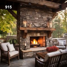 an outdoor fireplace with two chairs and a table in front of it on a patio