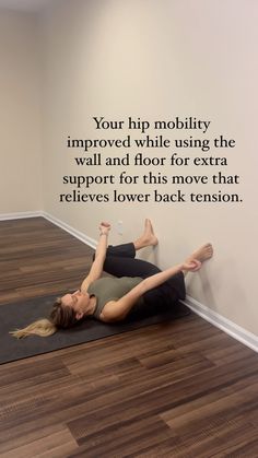 a woman is doing yoga on a mat in front of a wall with a quote